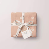 Salmon poppy swaddle folded and tied with twine and tag